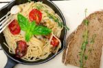 Spaghetti Pasta With Baked Cherry Tomatoes And Basil Stock Photo