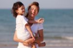 Asian Woman Hold The Boy On Beach Stock Photo