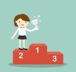 Business Concept, Business Woman Standing On 2nd Winning Podium And Holding Silver Trophy Stock Photo