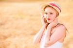 Lonely Beautiful Young Blonde Girl In White Dress With Straw Hat Stock Photo