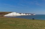 Seaford, Sussex/uk - April 5 : Man Sitting On A Bench Overlookin Stock Photo