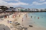 People Enjoying The Beach And Sea At Puerto Del Carmen Stock Photo