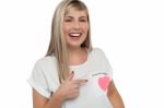 Pretty Teen Pointing Towards Pink Paper Heart Stock Photo