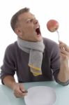 Man Holding Apple With Fork Stock Photo