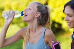 Running Girl Drinking Water After Running Stock Photo