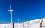 Wind Turbine And Blue Sky In Winter Landscape Stock Photo