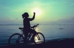 Silhouette Of Happy Female Celebrating With Arm Up Towards The S Stock Photo