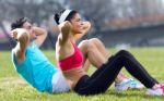 Young Couple Doing Push-ups Stock Photo