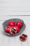 Fresh Pomegranate Fruits Isolated On A White Wooden Background Stock Photo