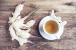 Ginger Tea In A White Cup On Wooden Background Stock Photo