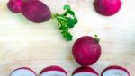 The Radishes On The Wooden Background Stock Photo