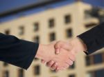 Handshaking Business People Stock Photo