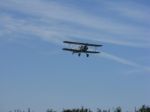 Biplane In Flight With Clouds Stock Photo