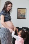 Pregnant Woman And Her Daughter Stock Photo