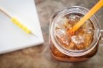 Glass Of Cola With Ice On Wooden Table Stock Photo