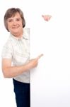 Old Lady Pointing At Blank Board Stock Photo