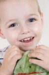 Smiling young child holding toy Stock Photo