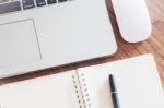 Notepad And Laptop On Wood Table Stock Photo