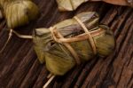 Khao Tom Mat - Thai Dessert - Sticky Rice, Banana And Black Beans Wrapped In Banana Leaf Stock Photo