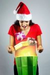 Beautiful Santa Girl Watching Out Gifts From A Magic Shopping Ba Stock Photo