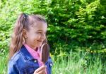 Smiling Girl Eating Ice Cream Stock Photo