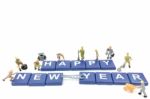 Miniature Worker Team Building Word Happy New Year On White Background Stock Photo