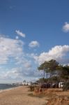 Beach And Cliffs In Quarteira Stock Photo