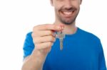 Smiling Guy Offering House Key Stock Photo