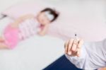 Doctor Preparing An Injection For A Little Asian Girl Stock Photo