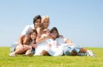 Happy Family Relaxing In Garden Stock Photo