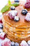 Pile Of Pancakes With Blueberries And Raspberries Sprinkled With Stock Photo