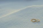 Wedding Rings In The Snow Stock Photo