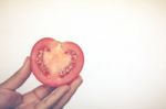 Half Cut Of Red Potato In Human Hand Stock Photo