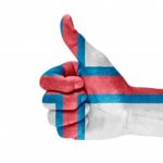 Flag Of The Faroe Island On Thumb Up Hand Stock Photo