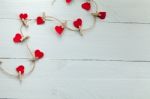 Small Hearts Subjects With Clothespins On White Background Stock Photo