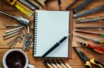 Tools Equipment With Coffee And Notebook On Wood Stock Photo