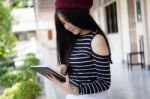 Portrait Of Thai Teen Beautiful Girl Using Her Tablet Stock Photo