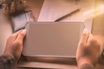 Hand Of Holding Tablet On Desk Stock Photo