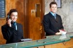 Young Receptionist Talking Phone Stock Photo