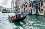 Gondoliers Ferrying People In Venice Stock Photo