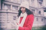 Woman In Red Coat And Wool Cap And Gloves With Smartphone In Han Stock Photo