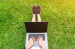 Young Woman Using Laptop In Park Stock Photo