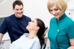 Dentist And Patient Under Discussion Stock Photo