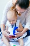 Mother And Baby Girl Using A Smartphone At Home Stock Photo