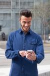 Young Man Using A Smart Phone Stock Photo