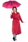 Gorgeous Lady With Umbrella Walking Towards You Stock Photo