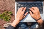 Human Hands Typing A Laptop Stock Photo