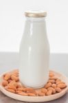 Almond Nuts On Wooden Plate With Milk Stock Photo