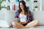 Beautiful Young Woman Listening To Music At Home Stock Photo