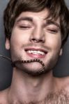 Portrait Of A Young Handsome Man With Snake On His Face Stock Photo